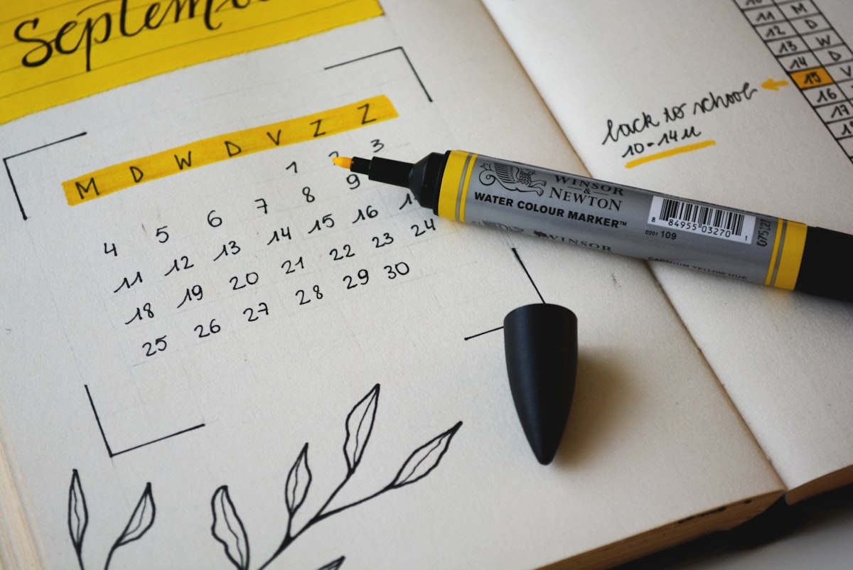 Hand-drawn calendar in a notebook with days highlighted